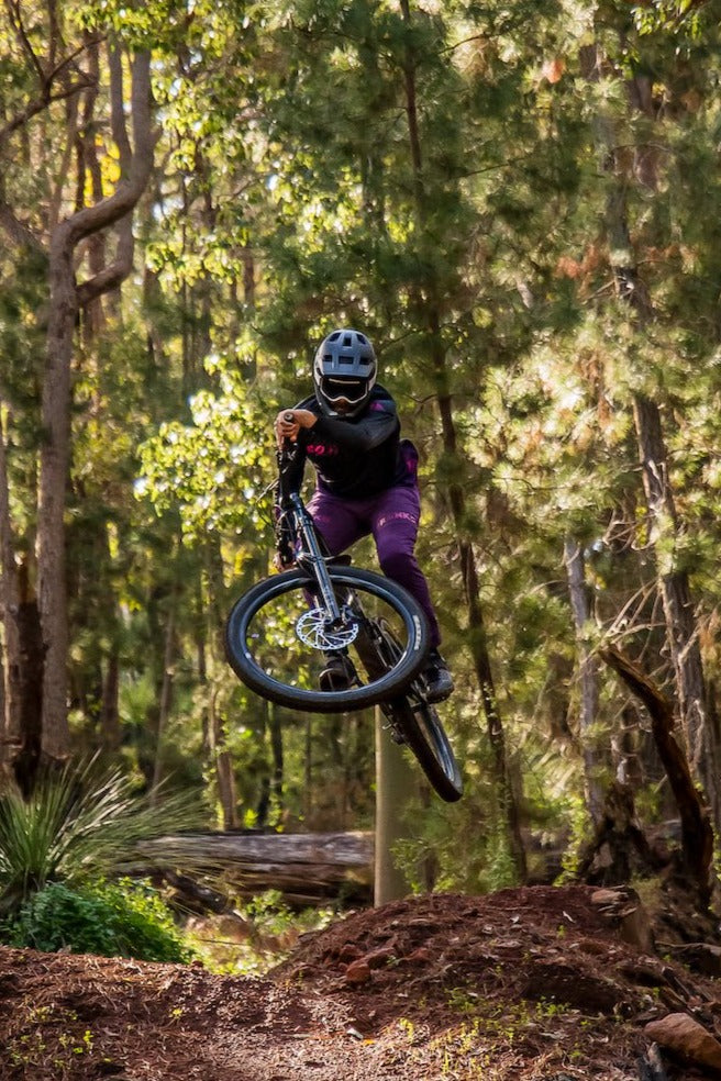 Purple darkside pants on male mtb rider